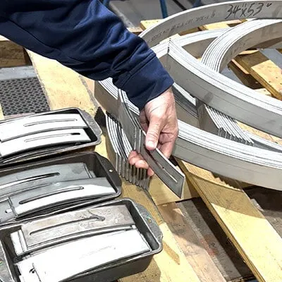 Holding up a metal ear for the retaining bands