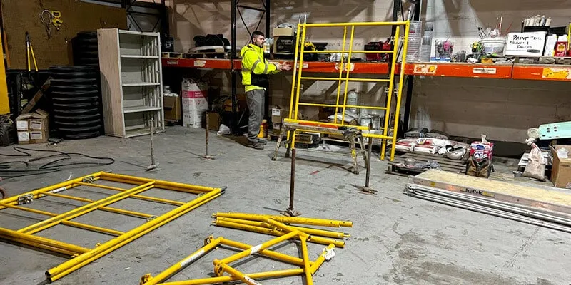 Constructing yellow scaffolding in the HydraTech work area
