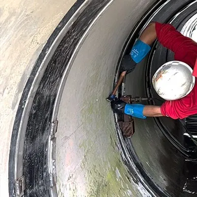 A technician inserting a wedge into a HydraTite seal, locking it in place