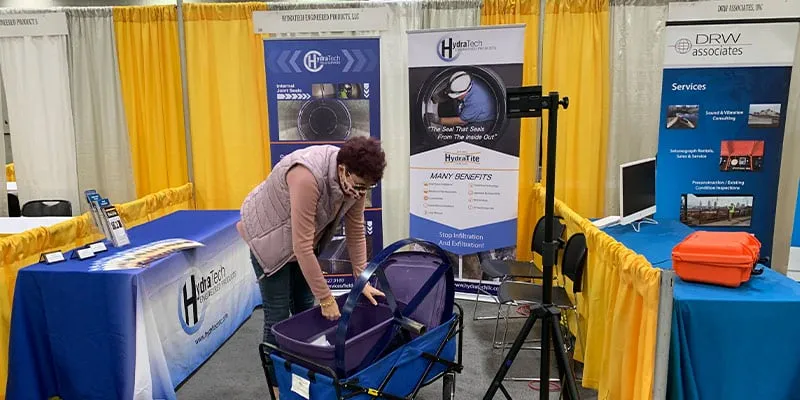 A woman putting together a trade show booth
