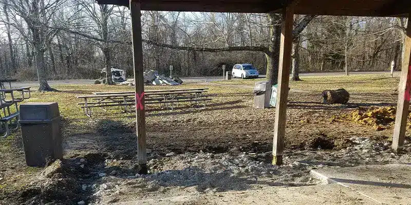 A row of pavilion posts that have degraded with age