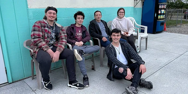 A group of HydraTech employees sitting on a porch