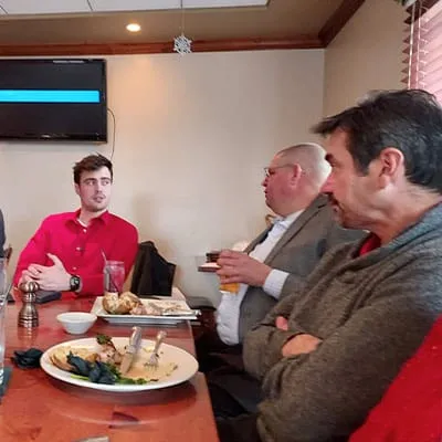 HydraTech personnel sitting at the Christmas lunch, talking