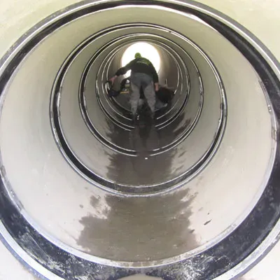 Technicians installing HydraTite over joints inside a pipe
