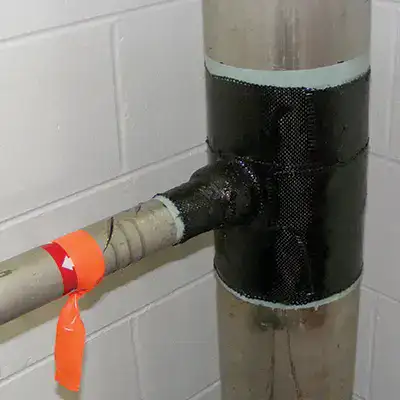 A tee fitting pipe wrapped in HydraWrap to restore this portion of pipe