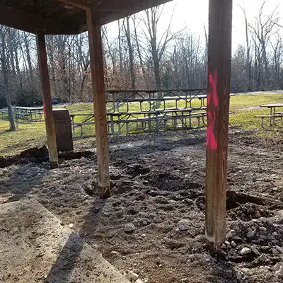 A row of pavilion posts that have degraded with age