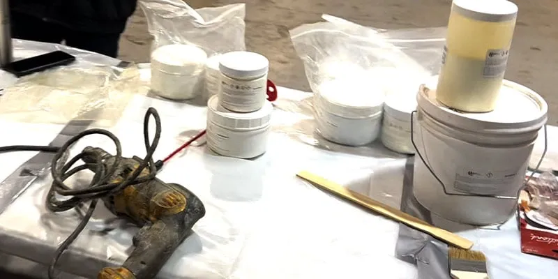 Several tubs of epoxy on a table prepared for a HydraWrap application