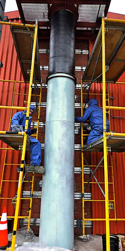 A pair of technicians applying a HydraWrap to the exterior of a vertical digester mixing pipe
