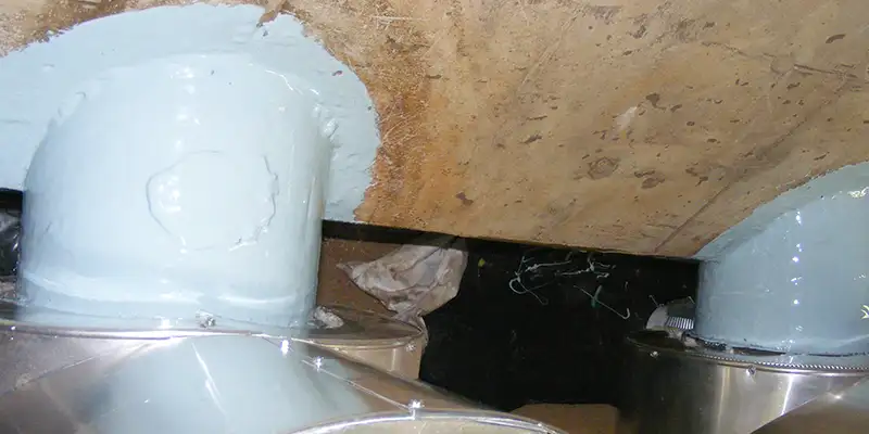 A portion of two cast-iron pipes coated in epoxy