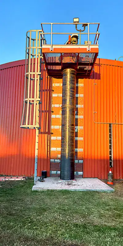 HydraWrap applied to a vertical digester mixing pipe to fortifying it against corrosion