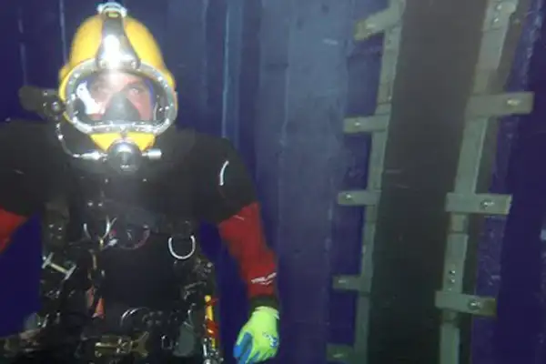 A diver near a recently installed HydraTite seal that is preventing leaks at this joint in a submerged box-shaped culvert
