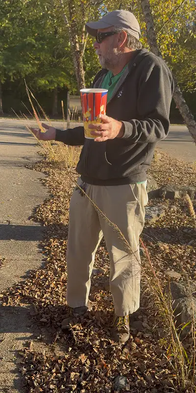 A man with a cup talking