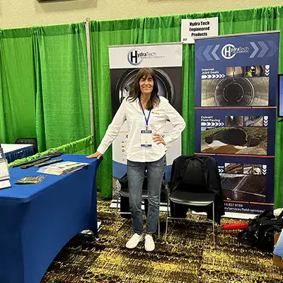 Jennifer standing at a tradeshow booth