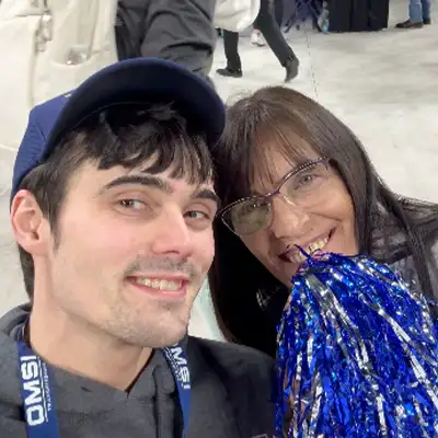 Caleb taking a selfie with Jennifer at a tradeshow.