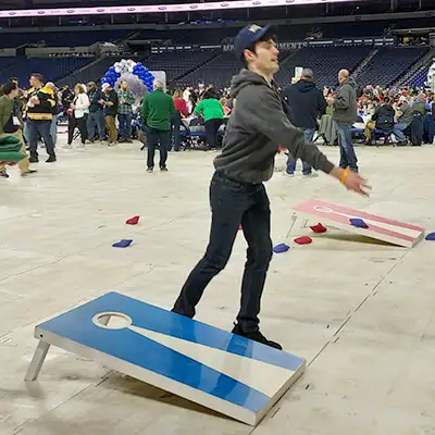 Caleb Rutledge playing corn hole at a trade show party