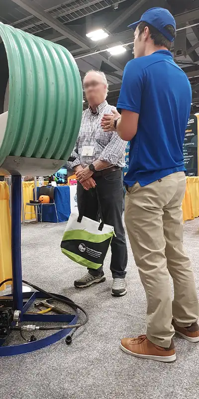 Caleb explaining the HydraTite installation process while motioning to the HydraTite demo seal right next to him