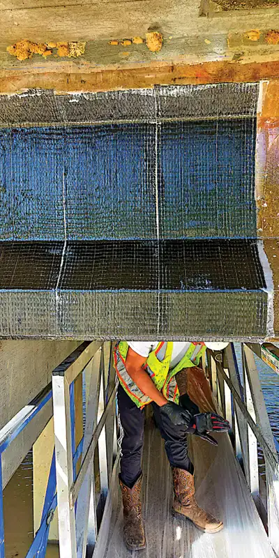 Carbon fiber fabric being applied to a portion of the underside of a bridge