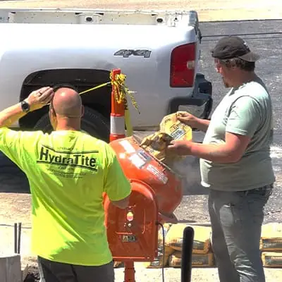 A couple technicians mixing concrete