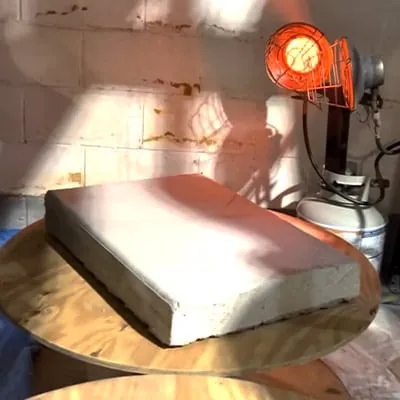 A small concrete slab near a heat lamp