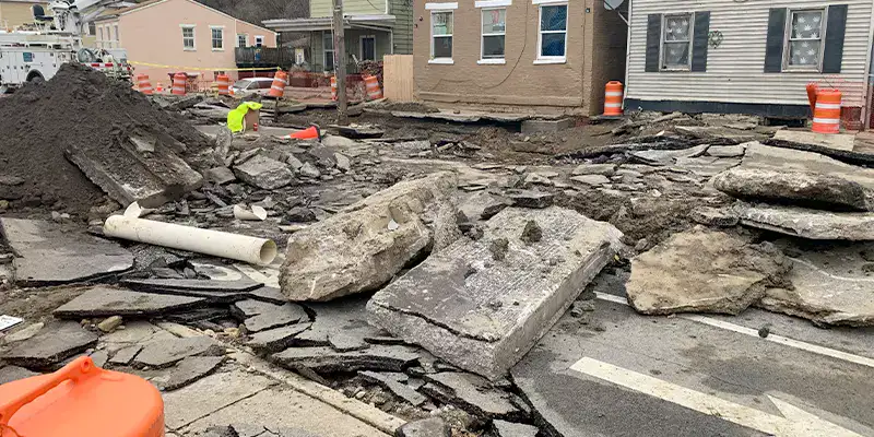 A damaged portion of road that has been severely damaged by a sinkhole