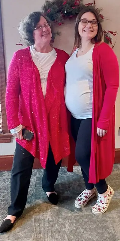 Two people standing together at the Christmas lunch