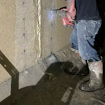 Holes being drilled into the interior of a box-culvert wall in preparation of HydraTite the internal pipe joint seal installation