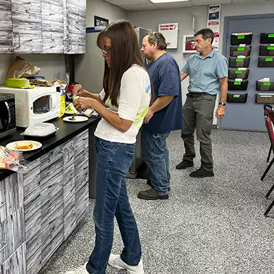 Several employees getting food at a group lunch