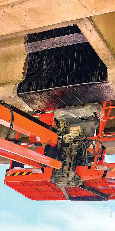 A portion of a bridge's underside that has been restored with carbon fiber fabric