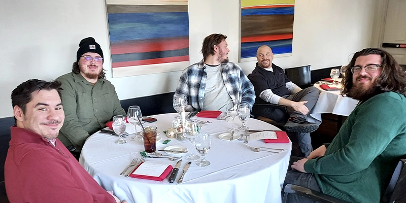 Several employees sitting for lunch at the yearly HydraTech Christmas lunch
