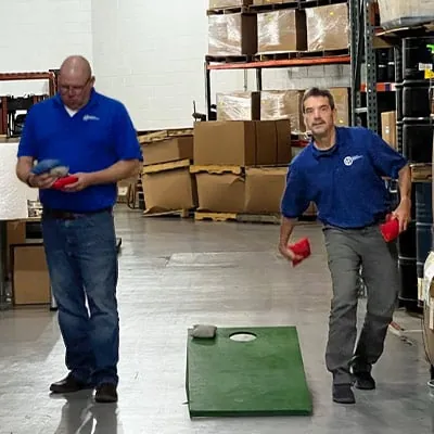 Peter and Mike Fox playing corn hole during a company team-building day