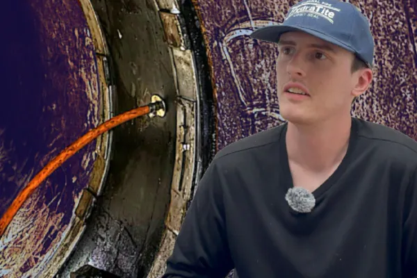 Colin sitting in front of a HydraTite seal that is being air tested to ensure that it has been installed correctly