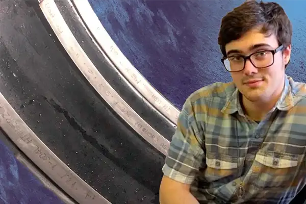 Caleb sitting in front of HydraTIte seal installed over a joint, sealing it