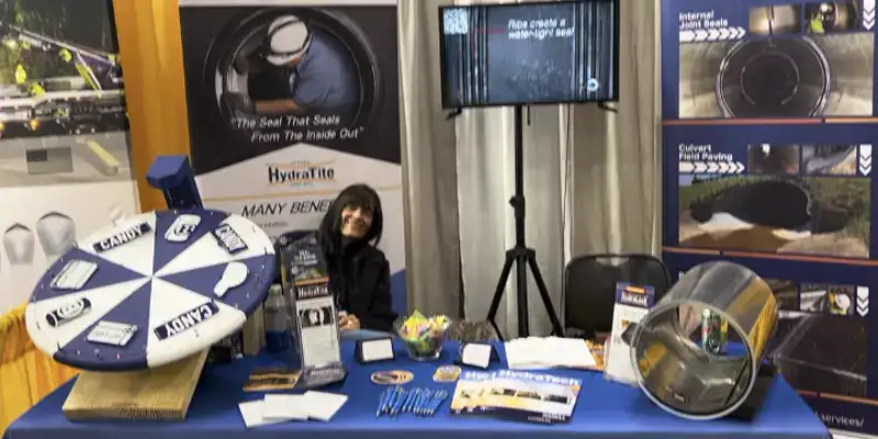 Jennifer sitting at the HydraTech tradeshow booth