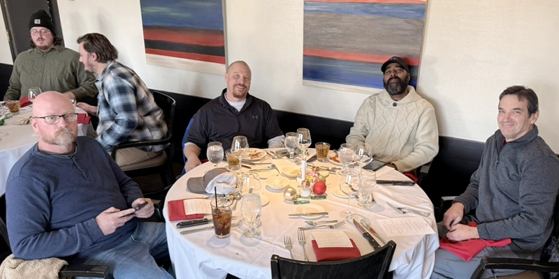 Several employees sitting for lunch at the yearly HydraTech Christmas lunch