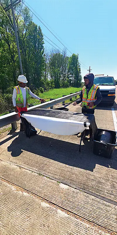 Two employees measuring our HydraWrap fabric