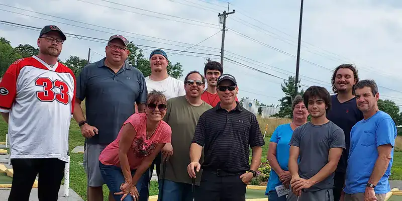 A group photo of HydraTech at a mini golf outing