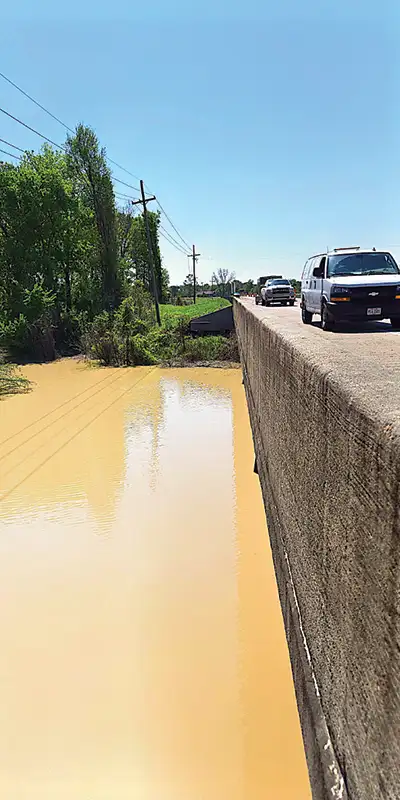 A couple vehicles parked on a bridge