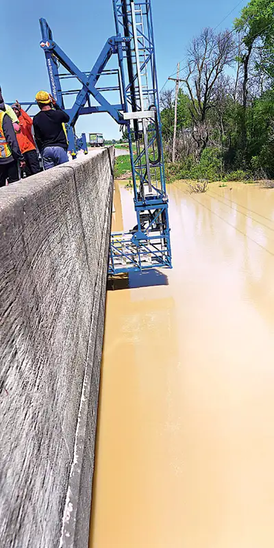 A lift being used to work on the underside of a bridge