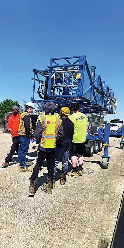 A group of employees gathered on a bridge
