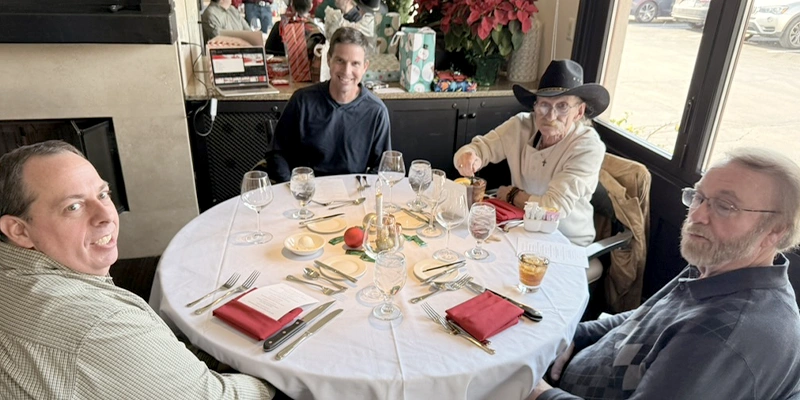 Several employees sitting at the yearly Christmas lunch