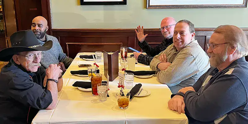 Several employees sitting at a table for Christmas lunch