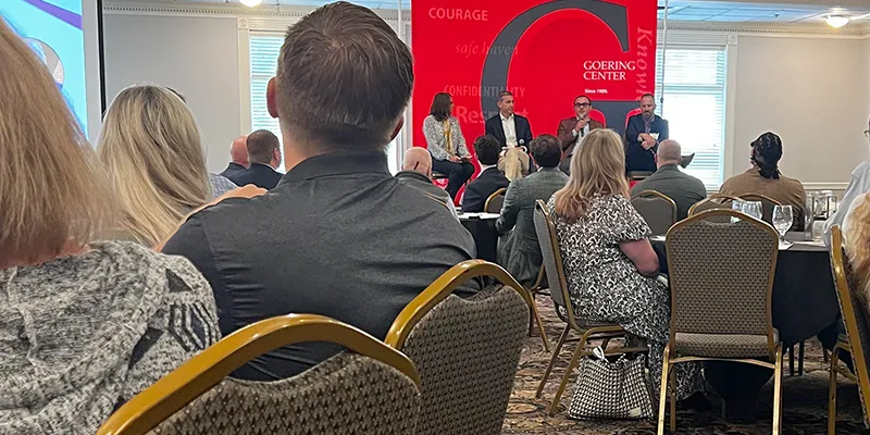 A group of people listening to a speaker