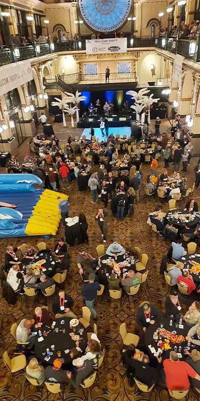 A large group of people gathered for dinner at the WWETT tradeshow