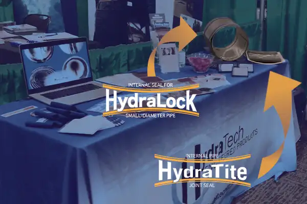 HydarTite and HydraLock on display on the HydraTech booth table at a tradeshow