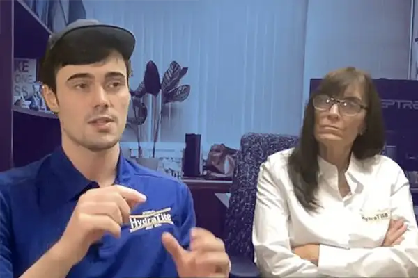 Two HydraTech employees explaining HydraTite
