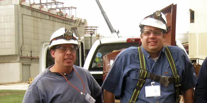 Two HydraTech employees at a power plant