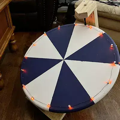 Orange lights around a prize wheel