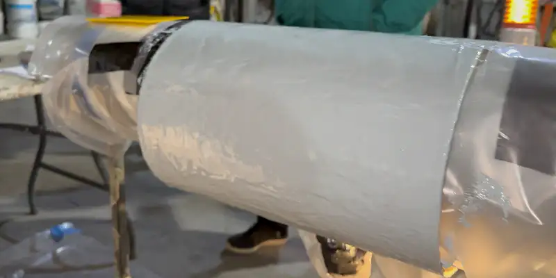 A section of cardboard pipe that has been coated in epoxy to demonstrate that step of the HydraWrap application