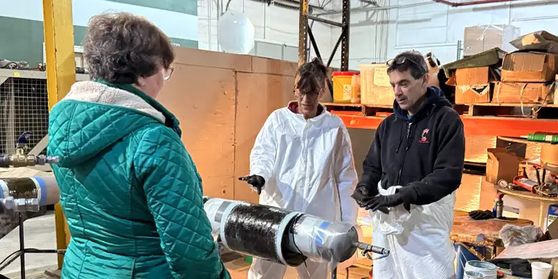 Several employees taking part in a HydraWrap application demonstration