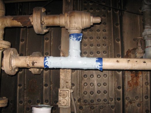 A tee fitting pipe that has had a portion of the pipe marked off and coated in HydraLine epoxy